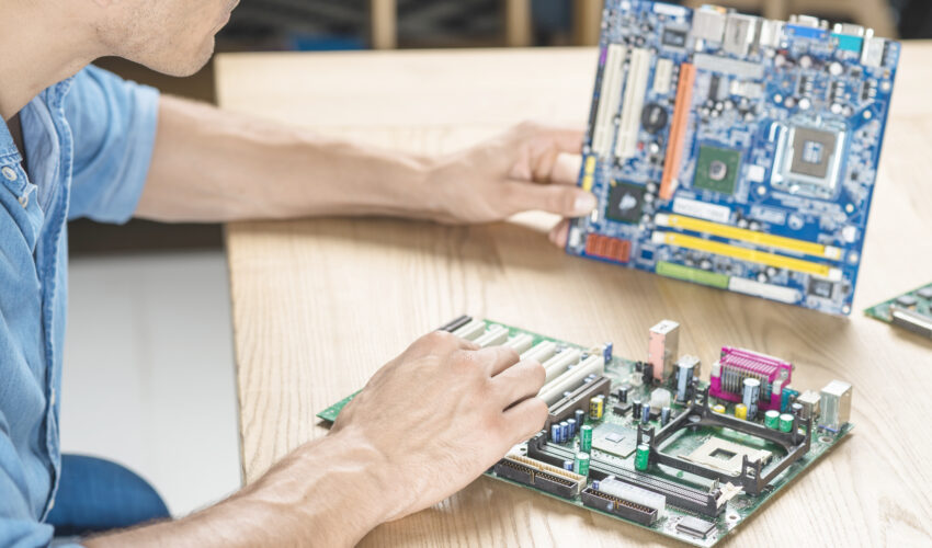 it technician upgrading motherboard wooden table Saravati