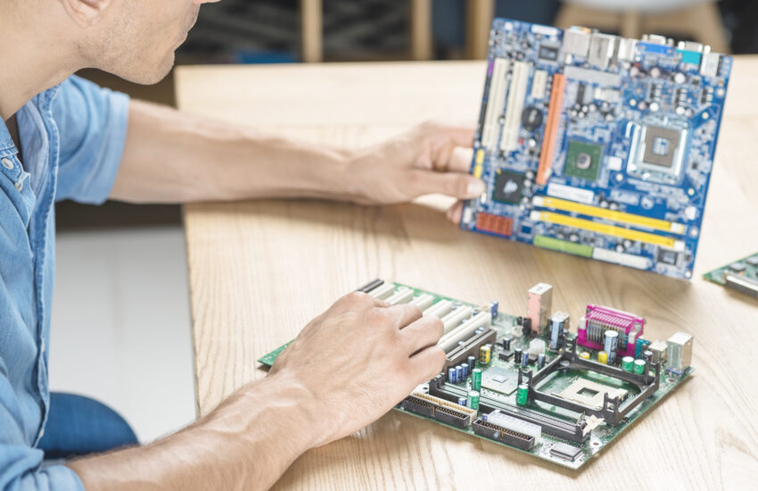 it technician upgrading motherboard wooden table Saravati