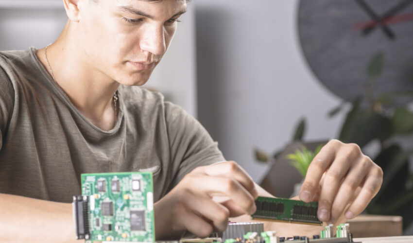 male it technician inserting ram memory computer motherboard Saravati
